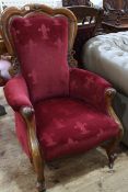 Victorian mahogany shaped back armchair in wine coloured fabric.