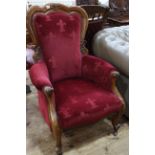 Victorian mahogany shaped back armchair in wine coloured fabric.