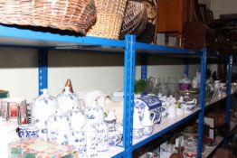 Full shelf of glass, china, soft goods, dinner and teaware, blue and white china, clock, etc.