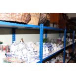 Full shelf of glass, china, soft goods, dinner and teaware, blue and white china, clock, etc.