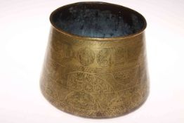 Antique Islamic brass bowl decorated with script and motifs, height 20cm.