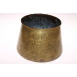 Antique Islamic brass bowl decorated with script and motifs, height 20cm.