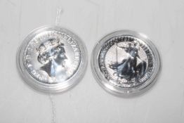 Two silver 1oz Britannia coins.