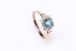 Blue topaz and ten stone diamond cluster ring set in 9 carat gold, size R.