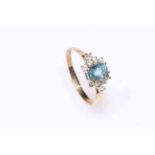 Blue topaz and ten stone diamond cluster ring set in 9 carat gold, size R.