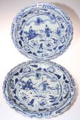 Pair of Chinese blue and white chargers decorated with figures on horseback, 40cm diameter.