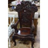 Oriental hardwood high back open armchair carved with dragons.