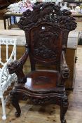 Oriental hardwood high back open armchair carved with dragons.