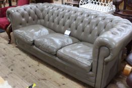 Taupe deep buttoned leather three seater Chesterfield settee, 200cm in length.