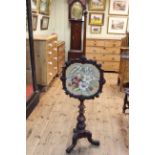 Victorian mahogany tripod pole screen having glazed floral needlework adjustable panel.