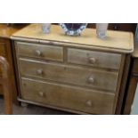 Waxed pine chest of two short above two long drawers on turned legs, 86cm by 107cm.