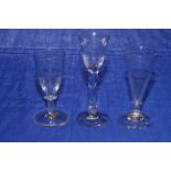 Three antique wine glasses.