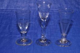 Three antique wine glasses.