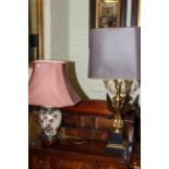 Ornate gilt metal eagle column table lamp and pottery table lamp with shade.