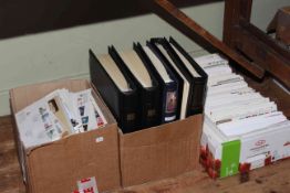 Three boxes with a large collection of first day covers, loose and in five albums.