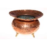 Benham & Froud, London copper jardiniere with embossed decoration and on three brass feet,