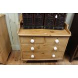Pine shaped gallery back chest of two short above two long drawers, 106cm by 98cm.
