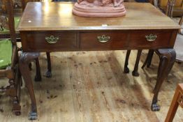 Late 19th/early 20th Century mahogany three drawer side table to paw feet, 77cm by 107cm.