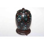Antique cloisonne tea canister and carved wood stand.