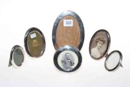 Collection of six small silver oval easel photograph frames.