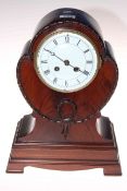 Edwardian mahogany balloon mantel clock raised on four bracket feet, 34cm.