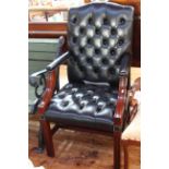 Black deep buttoned leather open armchair.