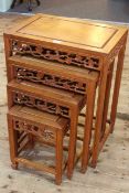 Quartetto nest of Oriental hardwood tables, all with fretwork friezes (largest 66cm by 51cm).