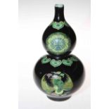 Chinese double gourd vase with panels of famille verte on black ground,