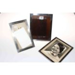 Three rectangular silver photograph frames, approximately 23cm by 14-18cm.