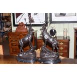 Pair of large impressive bronzes of stags on rocky outcrops, raised on marble plinths, 75cm high.