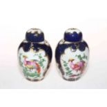 Pair of Worcester style Sampson vases and covers, with panels of birds in ornate gilt borders,