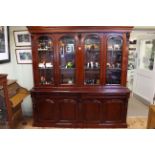 Victorian style mahogany cabinet bookcase having four arched glazed panel doors above four drawers