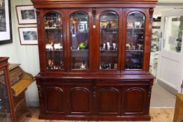 Victorian style mahogany cabinet bookcase having four arched glazed panel doors above four drawers