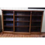 Late Victorian walnut breakfront open bookcase on plinth base with nine adjustable shelves,