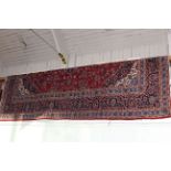 Large hand made wool pile Kashan carpet with classic floral central medallion design, 3.90 by 3.00m.