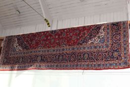 Large hand made wool pile Kashan carpet with classic floral central medallion design, 3.90 by 3.00m.