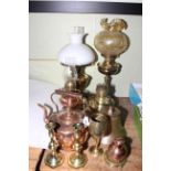 Oil lamps, shades, copper kettle, bell, goblet, Guernsey de la Rue copper milk pot, candlesticks.