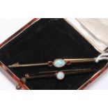 Two gold opal bar brooches, one with two rubies and one stamped 15 carat.