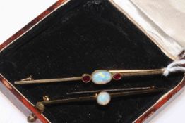 Two gold opal bar brooches, one with two rubies and one stamped 15 carat.