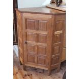 Colin Almack Beaverman oak panelled floor standing corner cupboard, 106cm by 81cm.