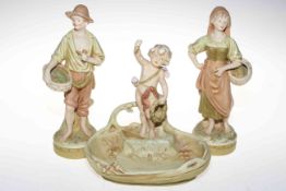 Three Royal Dux figures including cherub bowl and two village folk carrying baskets,