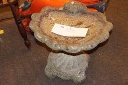 Weathered shell pedestal bird bath.