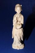 Large Japanese walrus ivory okimono of a geisha, red signature to base, 24cm.