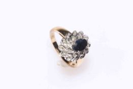 Oval sapphire and multi-stone diamond cluster ring set in 9 carat gold, size O.