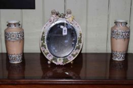 Floral encrusted and cherub framed easel mirror and pair of Japanese vases.