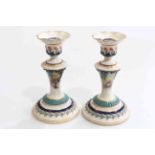 Pair of Hadley's Royal Worcester candlesticks, painted with berries, shape No. 265B, 15.5cm.