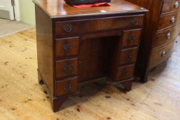 Georgian style mahogany kneehole desk having frieze drawer above a central inset cupboard door
