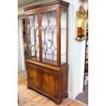 Good quality mahogany cabinet having two glazed panel doors above a pull out leather surface with