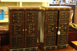 Pair of painted table top two door cabinets in the form of bookcases, 62cm by 40cm.