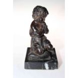 Small bronze of child seated on cushion, 22cm.